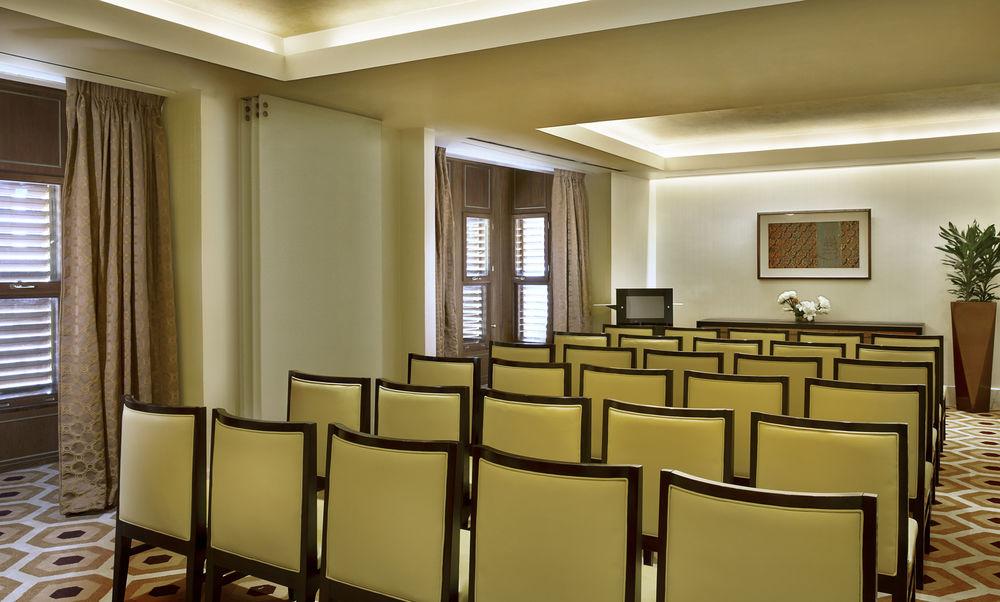 자발 오마르 메리어트 호텔, 마카 메카 외부 사진 The photo shows an indoor meeting or conference room. It features several rows of cream-colored chairs with dark wooden frames, all neatly arranged. The walls have soft lighting and there are large windows with closed curtains, allowing for a calm at